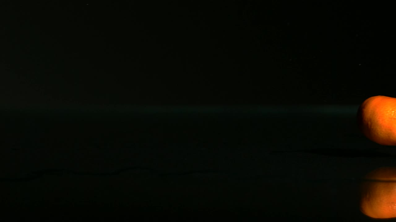 Free Video Stock tangerines rolling on a black surface Live Wallpaper