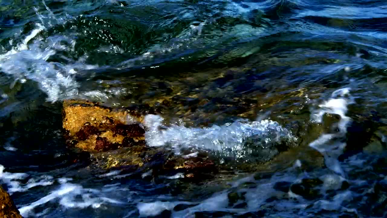 Free Video Stock texture of sea waves and shore rocks Live Wallpaper
