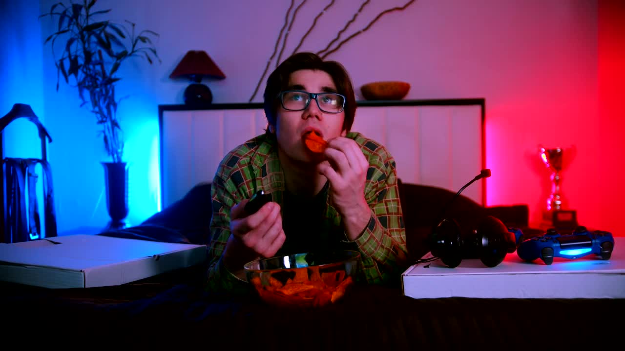 Free Stock Video Young Man Lying Down Watching Tv And Eating Snacks Live Wallpaper
