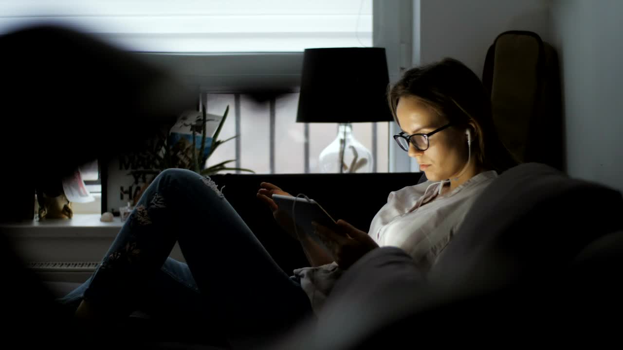 Free Stock Video Woman Using A Tablet Lying On The Couch Live Wallpaper