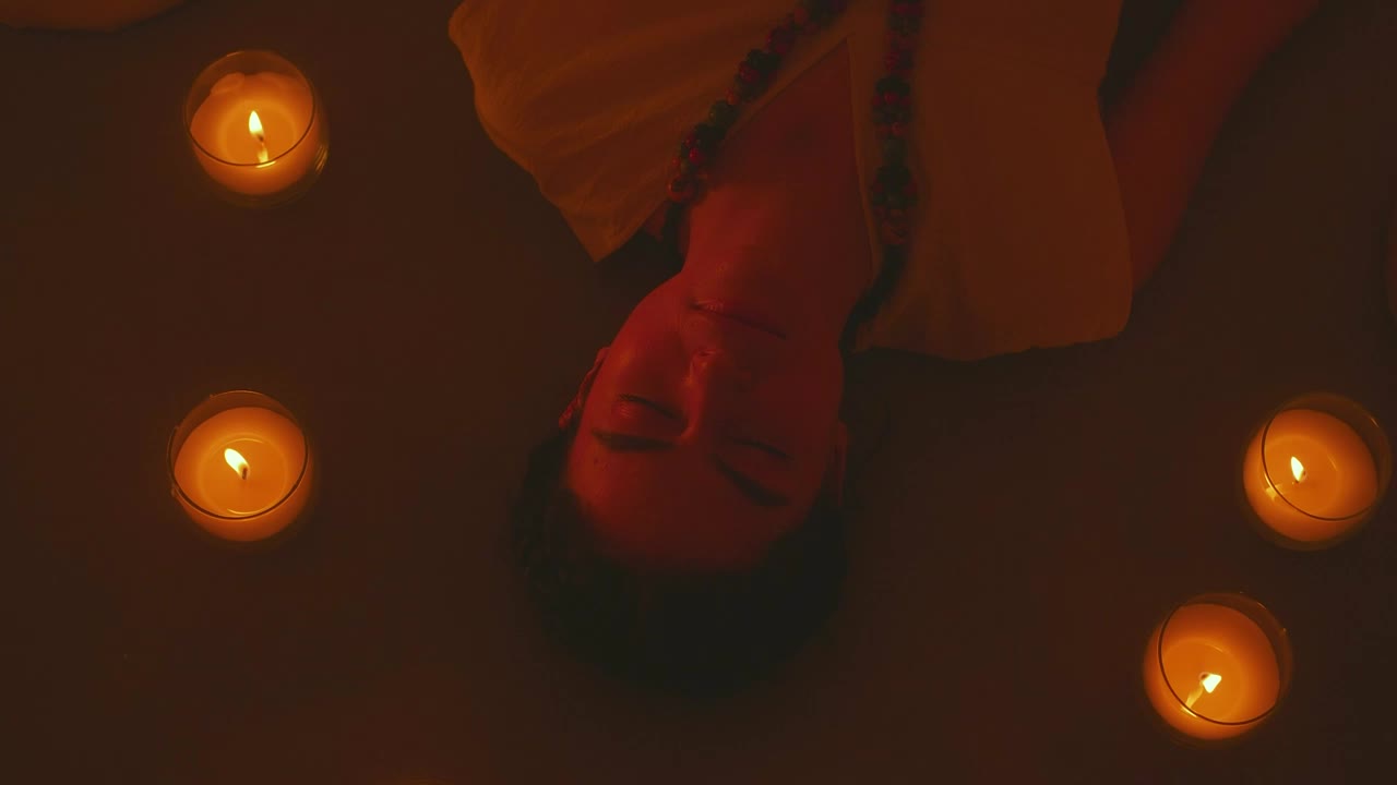 Free Stock Video Woman Meditating Lying On The Floor Between Some Candles Live Wallpaper