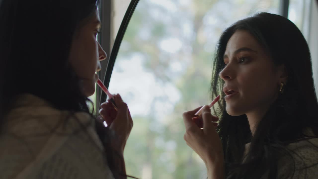 Free Stock Video Woman Applying Makeup In Front Of A Mirror Live Wallpaper