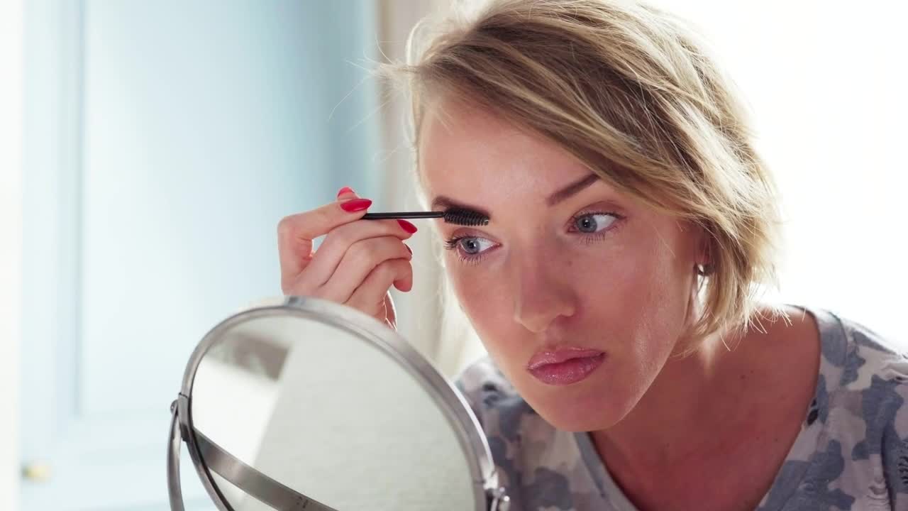   Stock Footage Woman Applying Mascara Live Wallpaper