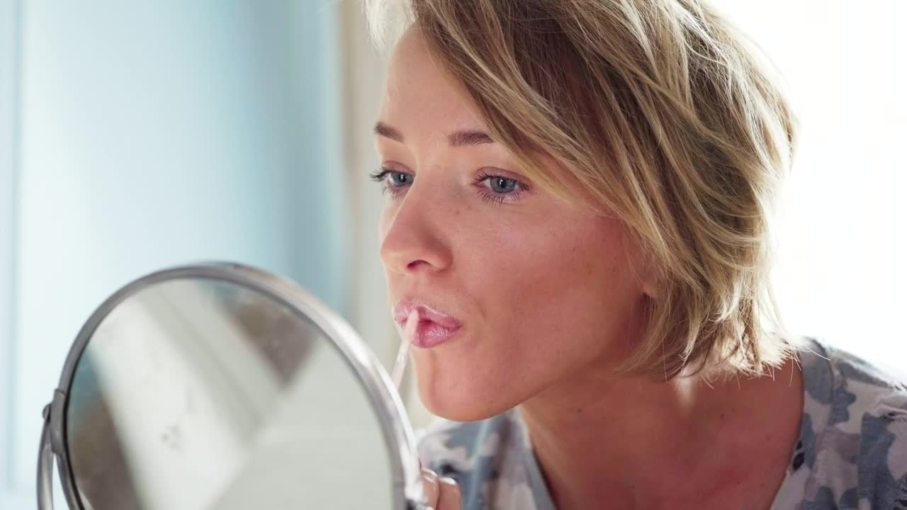   Stock Footage Woman Applying Lipstick Live Wallpaper