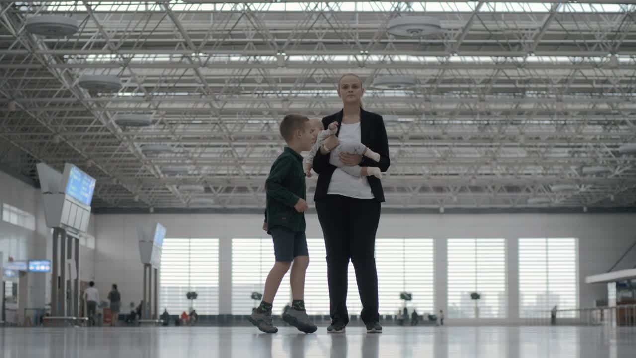   Stock Footage Woman And Her Kids At The Airport Live Wallpaper