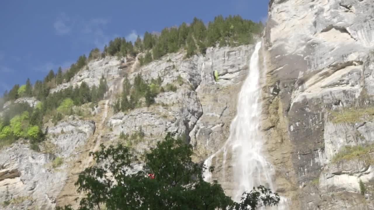   Stock Footage View Of A Rocky Mountain With A Pair Of Parachutes Live Wallpaper