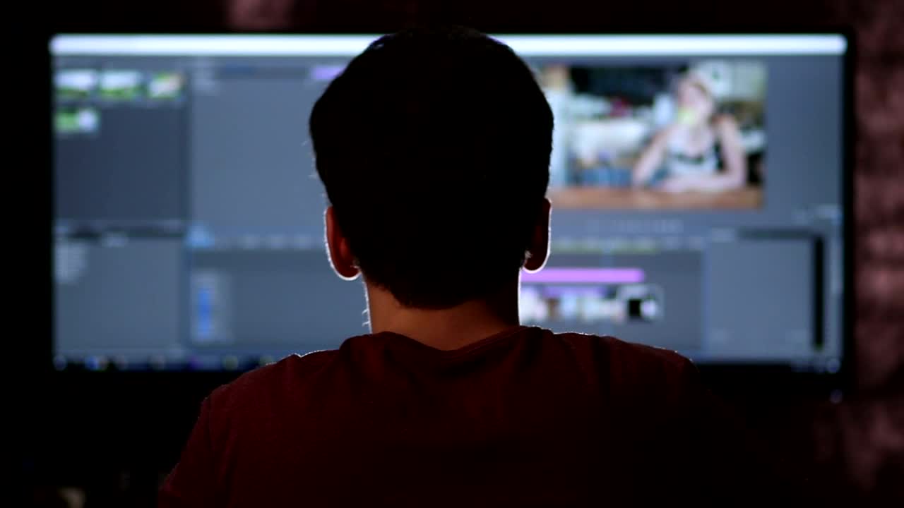   Stock Footage Video Editor Working On A Large Screen Live Wallpaper
