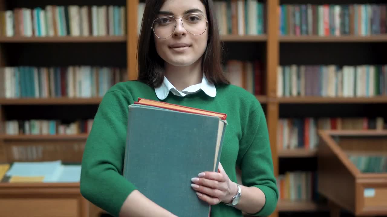   Stock Footage University Student Smiles And Holds Books Live Wallpaper
