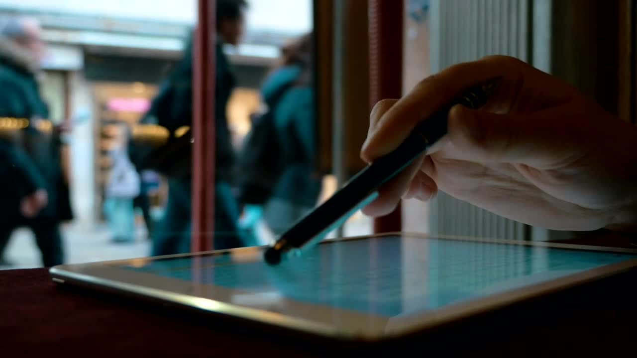   Stock Footage Typing On A Tablet In A Town Cafe Live Wallpaper