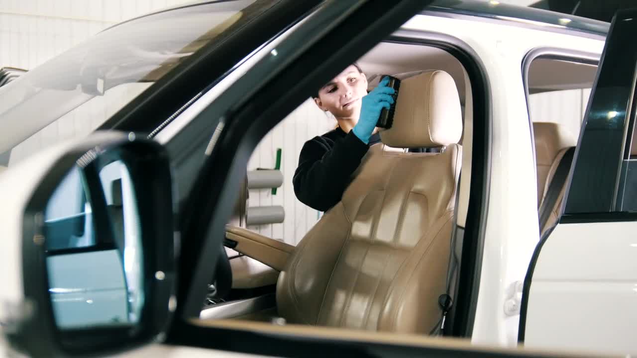 Stock Footage Young Woman Cleaning The Interior Of A Luxury Car Live Wallpaper Free