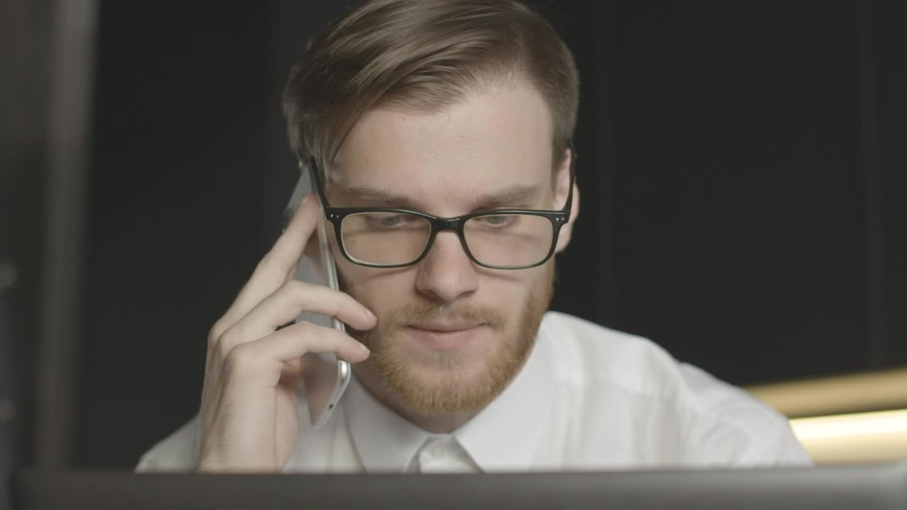 Stock Footage Worried Man On Phone Call Stares At Laptop Live Wallpaper Free