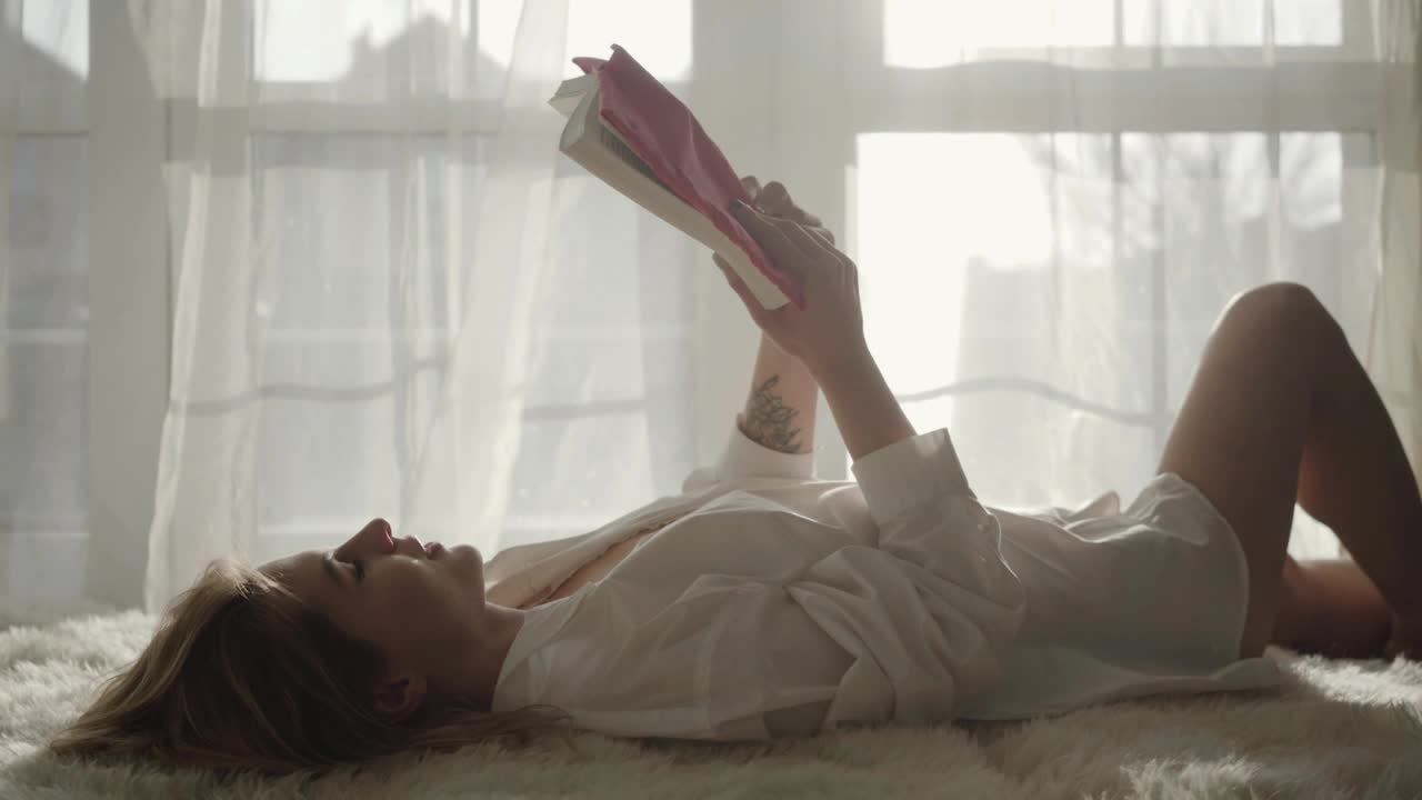 Stock Footage Woman Enjoys Reading Hobby By Sunny Window Live Wallpaper Free