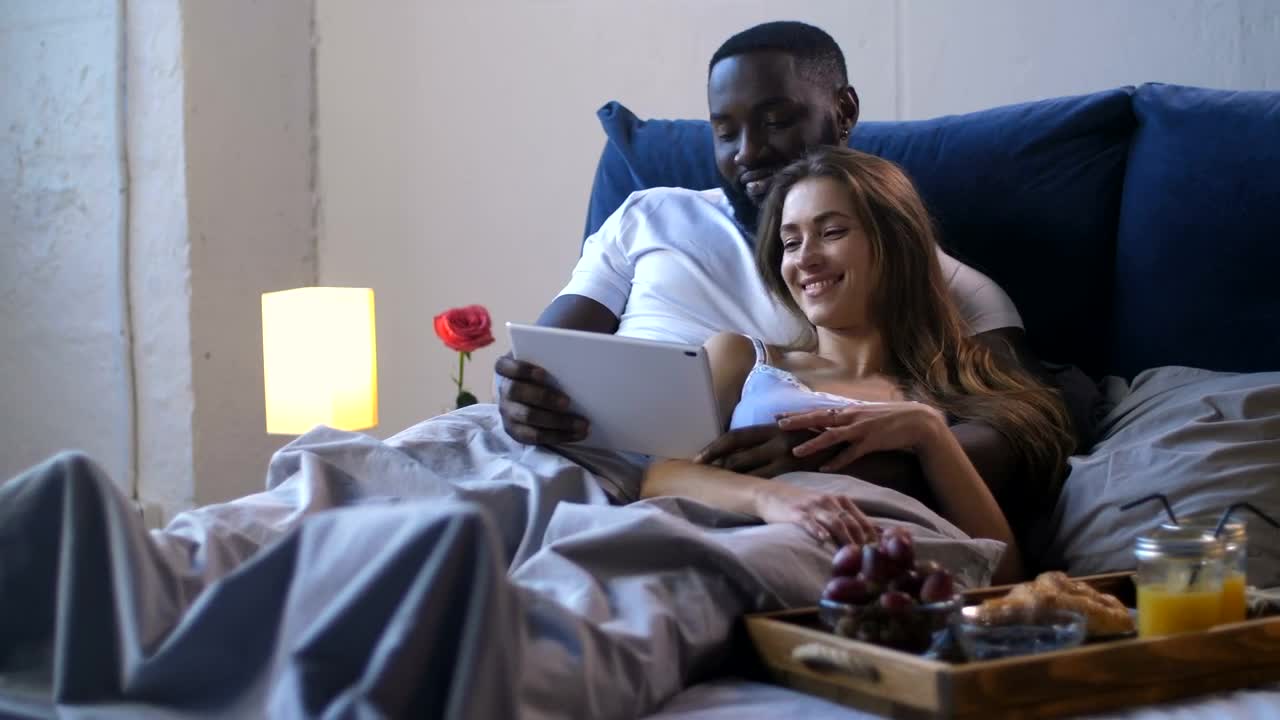 Stock Footage Young Couple Enjoying A Film In Bed Live Wallpaper Free