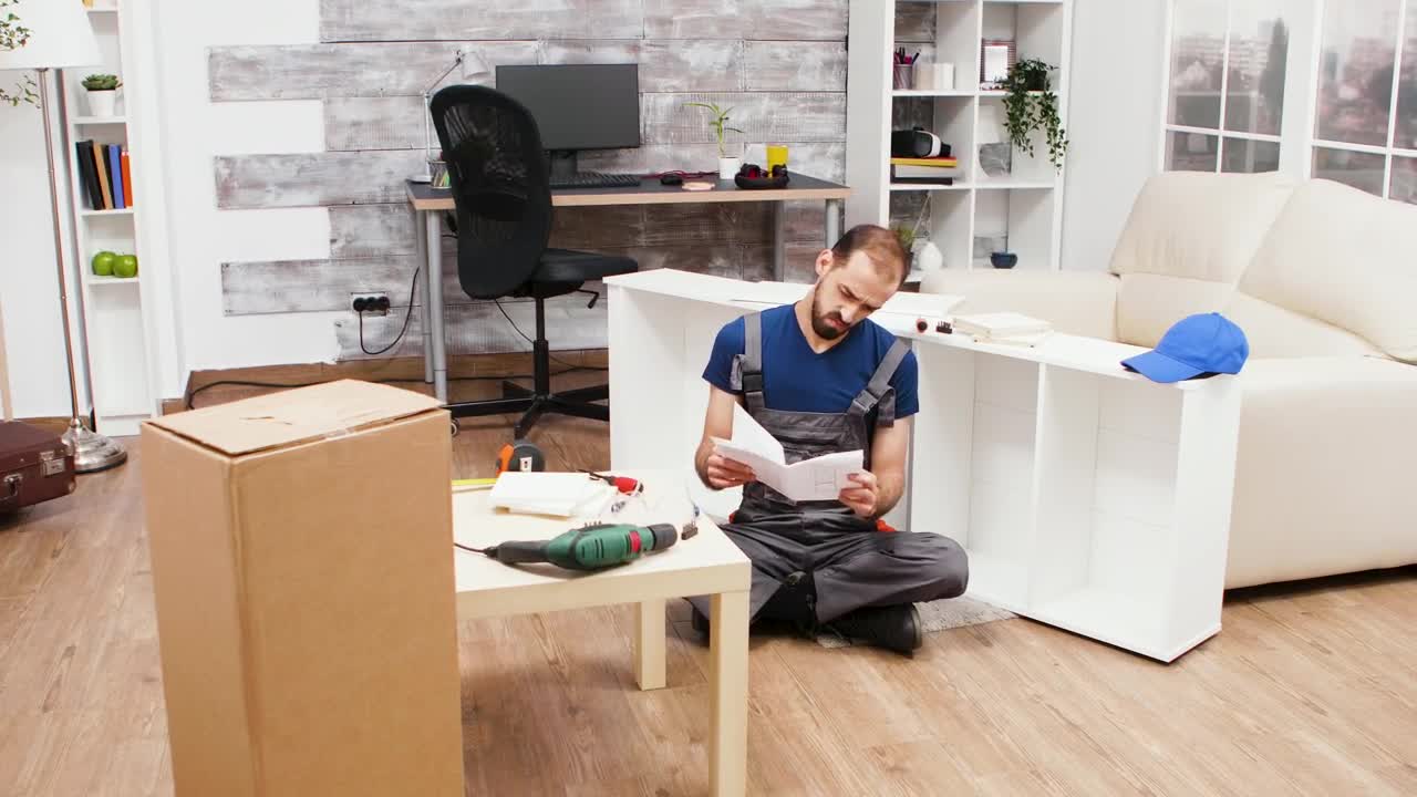 Stock Footage Young Man Trying To Build A Bookcase Live Wallpaper Free