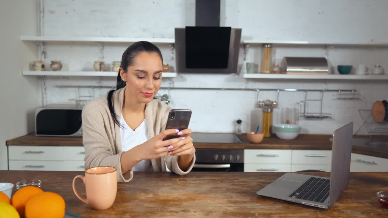 Stock Footage Woman In A Kitchen Typing On Her Smartphone Live Wallpaper Free