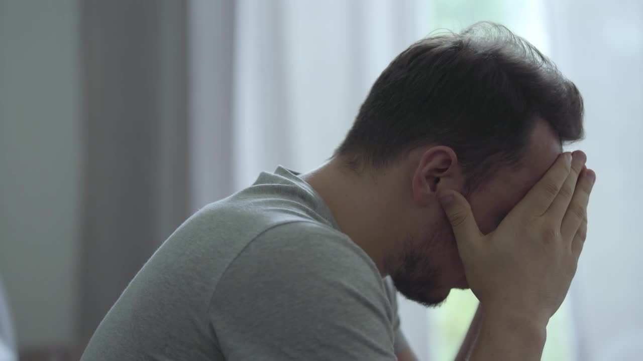 Stock Footage Worried And Sad Man With His Head Down Live Wallpaper Free
