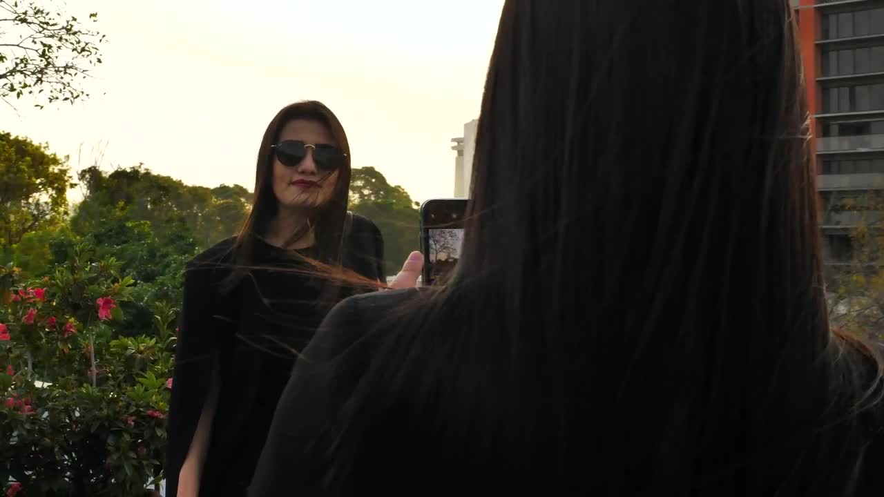 Stock Footage Woman Takes Photo Of Her Girlfriend Live Wallpaper Free